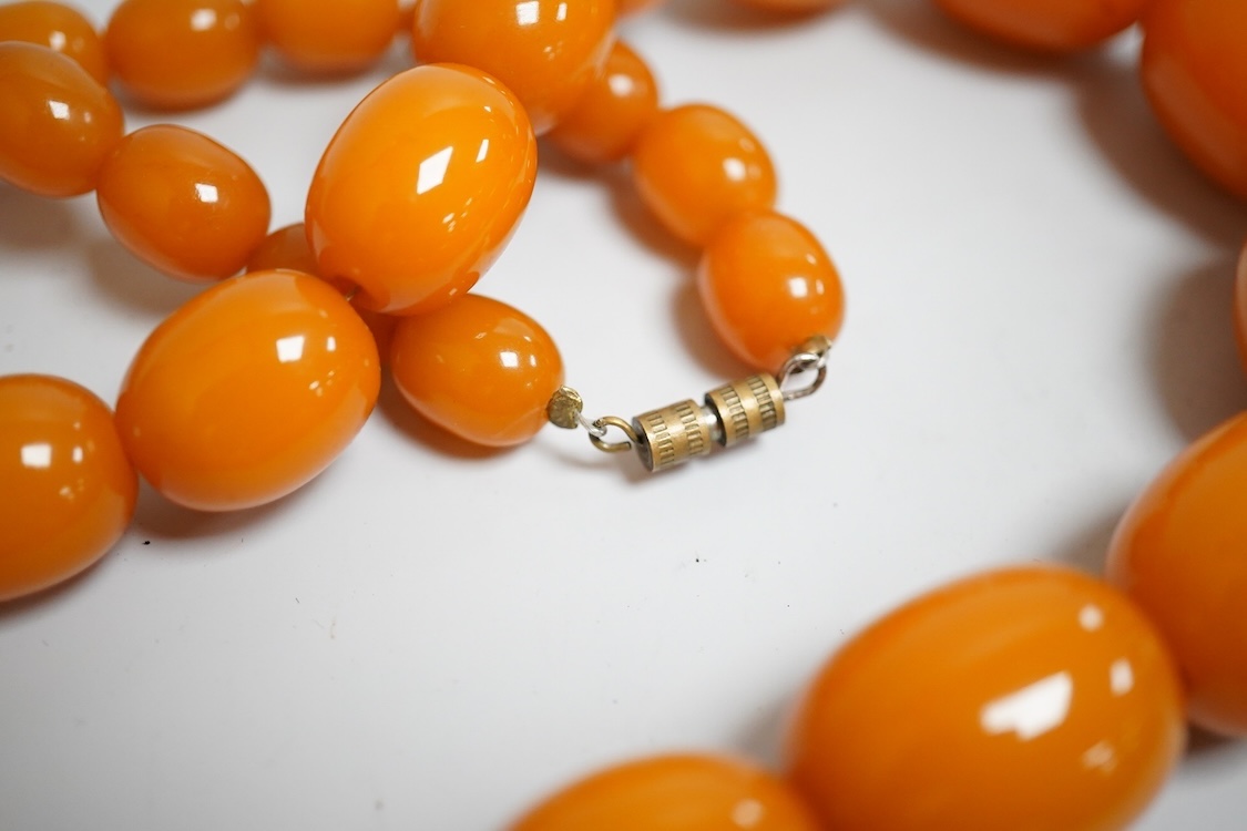 A group of antique and later jewellery inc. cased paste set spray brooch, a Mexican paste set brooch, a paste set shoe buckle and a pressed amber necklace.